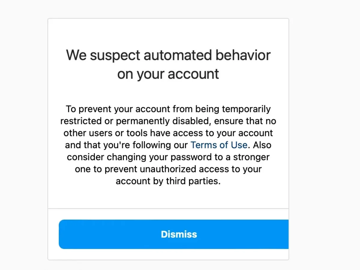 Instagram warning reading 'We suspect automated behavior on your account', with a Dismiss button.