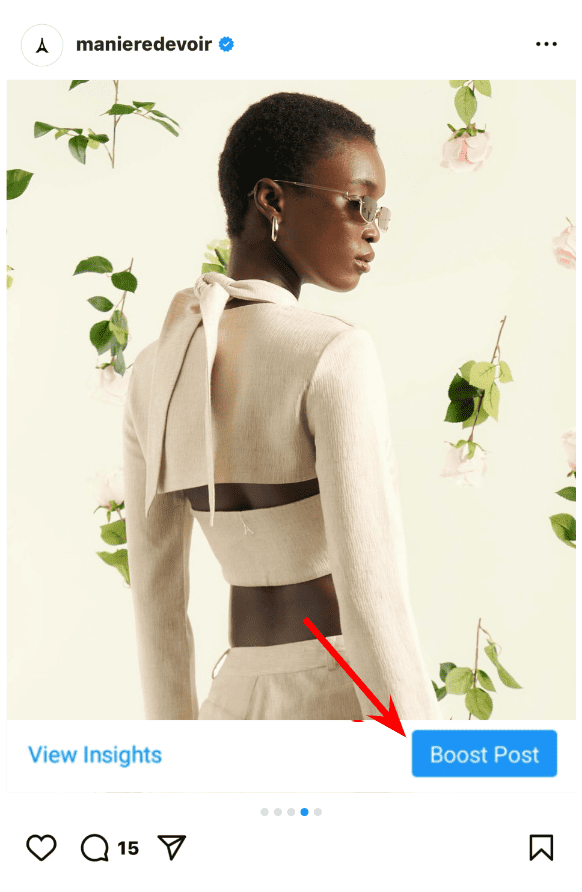 Instagram post with an arrow pointing to the Boost Post button below it.