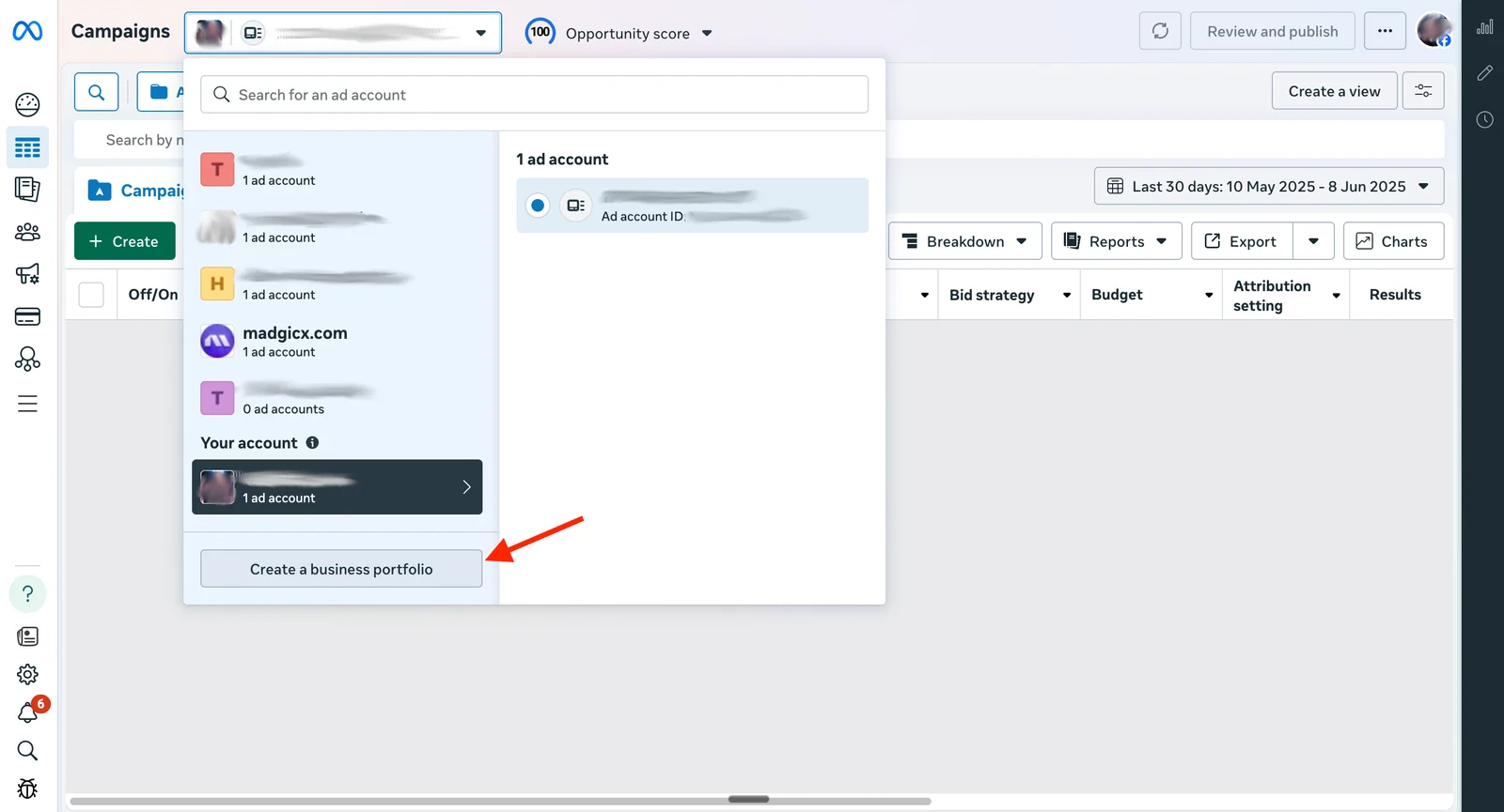 Meta Ads Manager account switcher with an arrow pointing to the Create a business portfolio button.