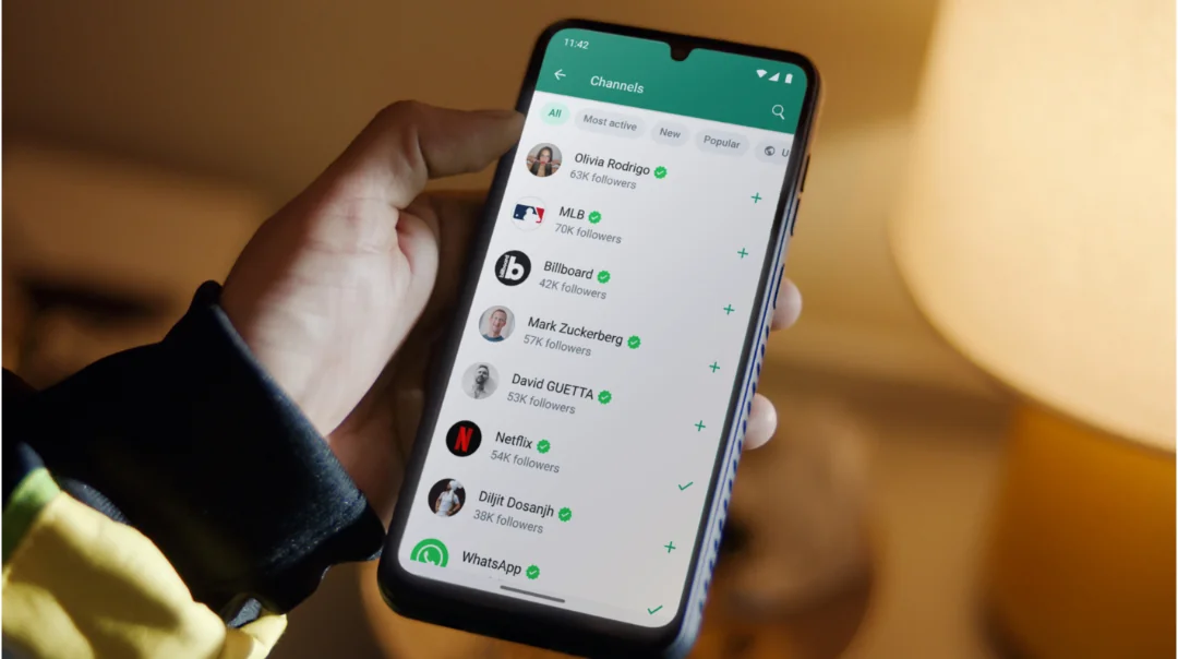 WhatsApp Channels directory on a phone, listing verified brands and creators to follow